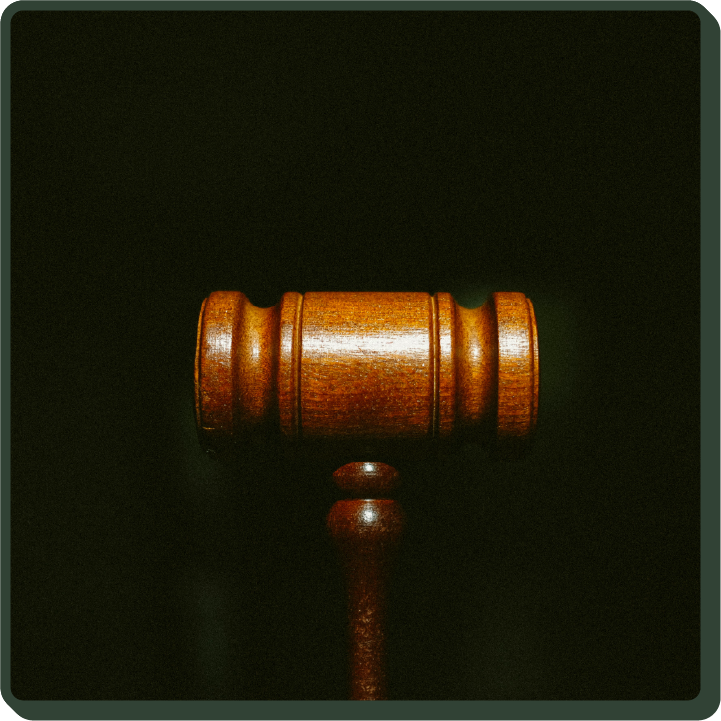 Photot of a gavel in front of a dark background, supporting our roots in justice