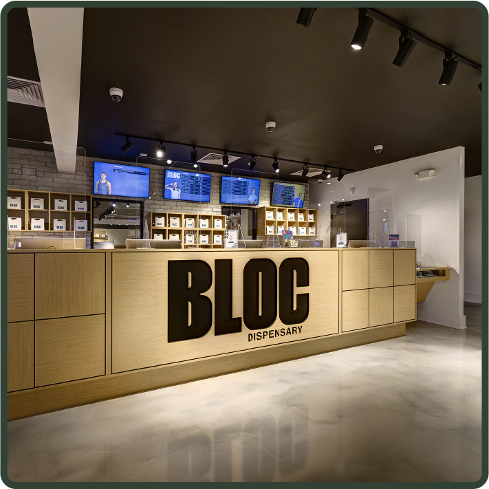 Inside of a Bloc dispensary, focused on the counter with large Bloc lettering on it