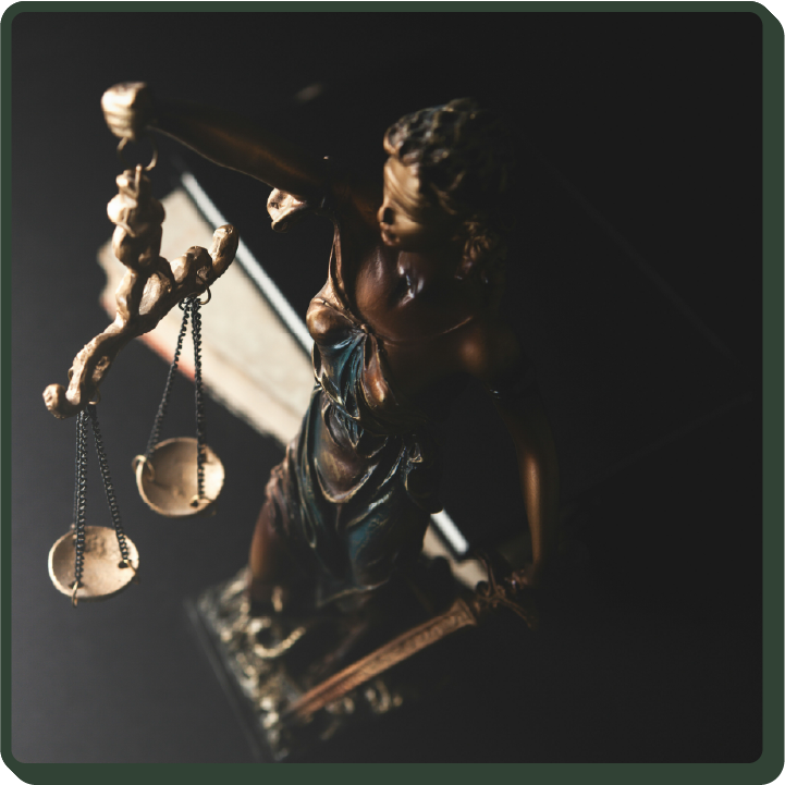 view of a bronze lady Themis statue in a dark room from above